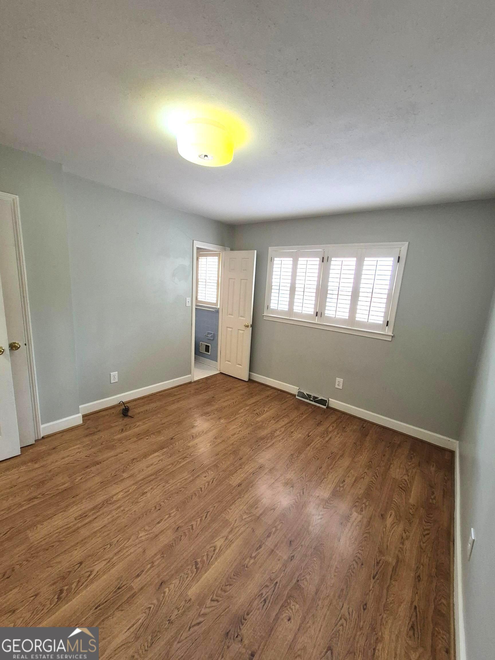 930 Hill Place Macon, GA 31210 - Photo 28 of 34 wooden floor in an empty room with a window