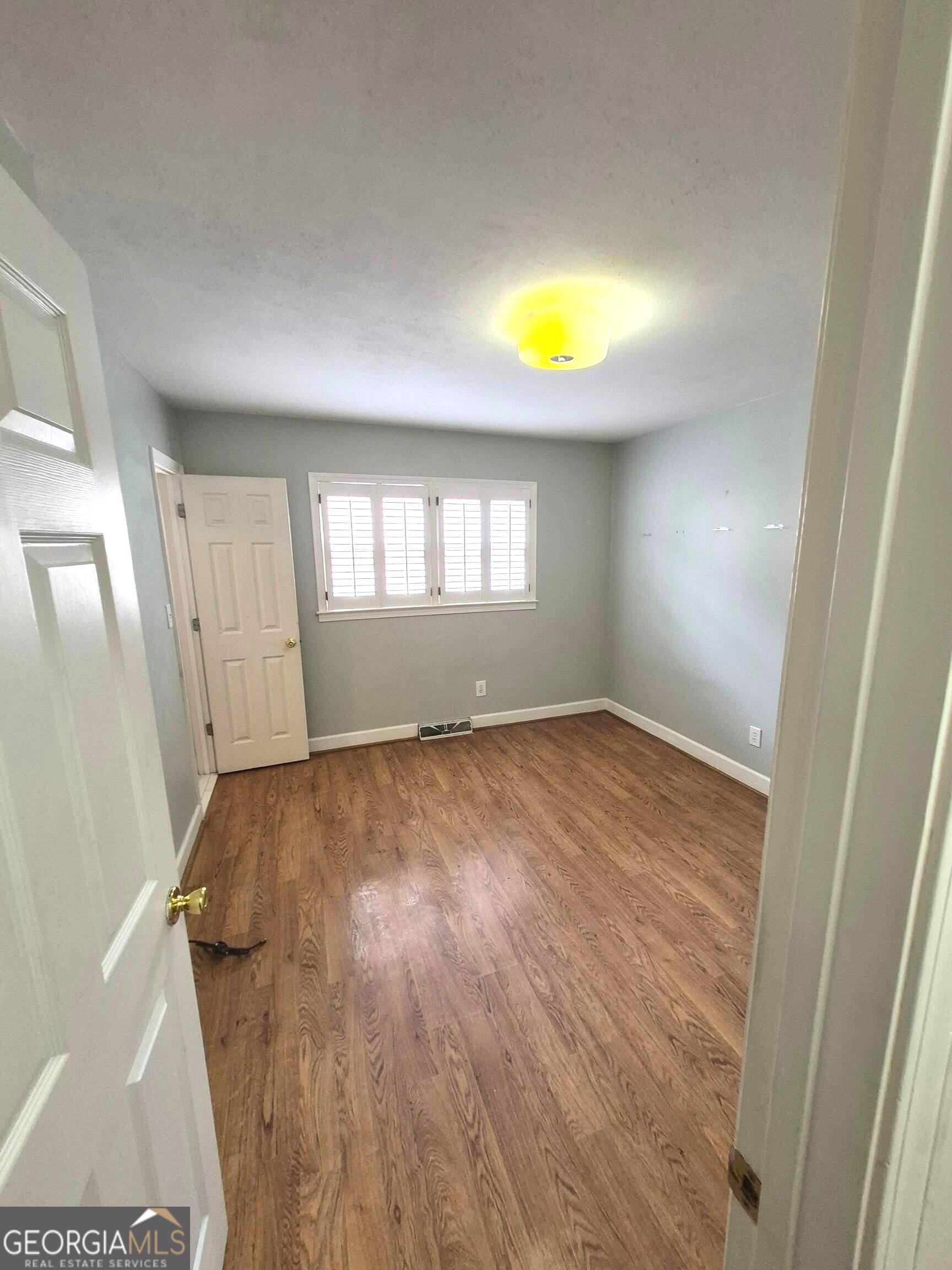 930 Hill Place Macon, GA 31210 - Photo 31 of 34 an empty room with windows and wooden floor