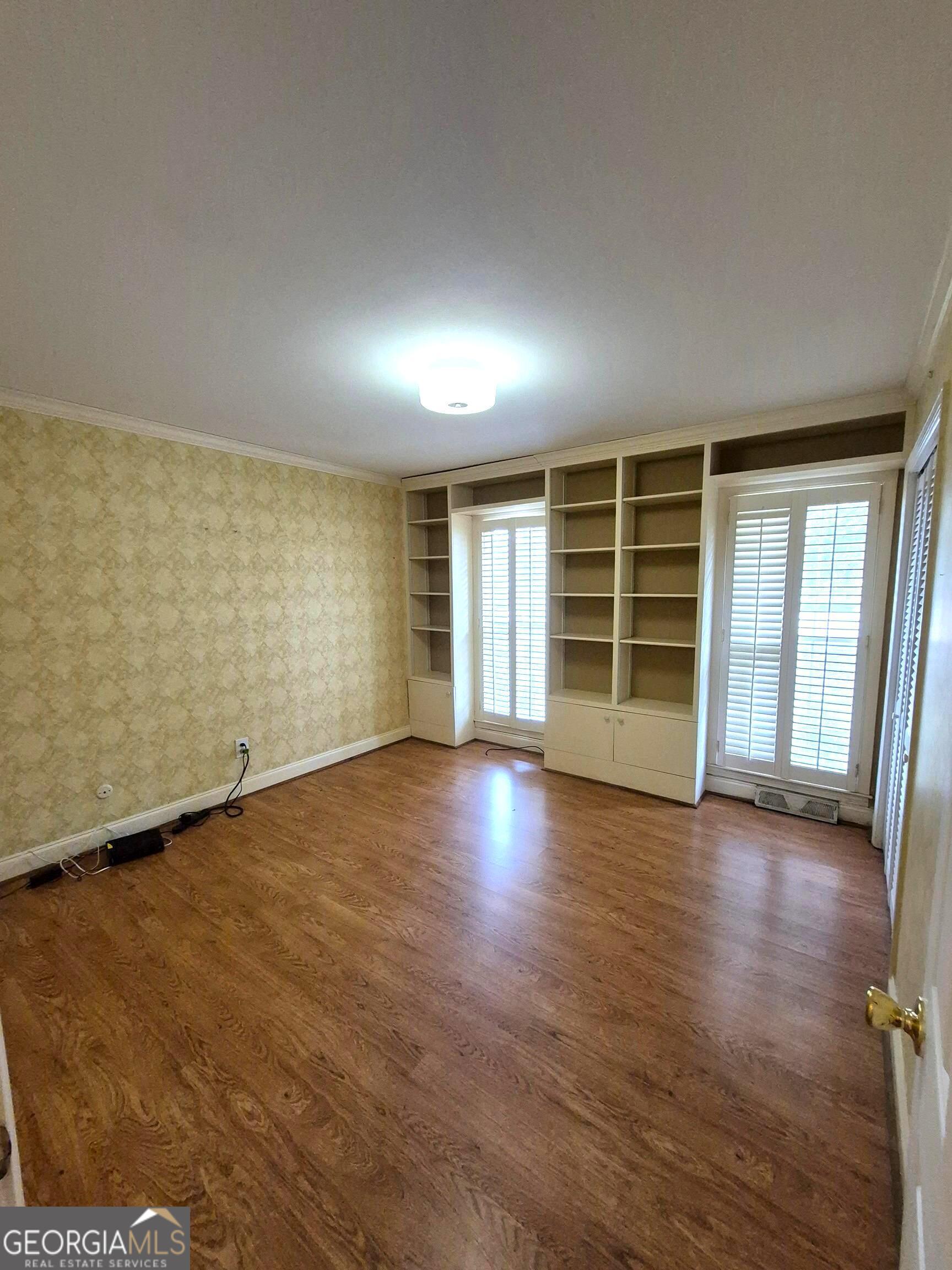 930 Hill Place Macon, GA 31210 - Photo 34 of 34 an empty room with wooden floor and windows