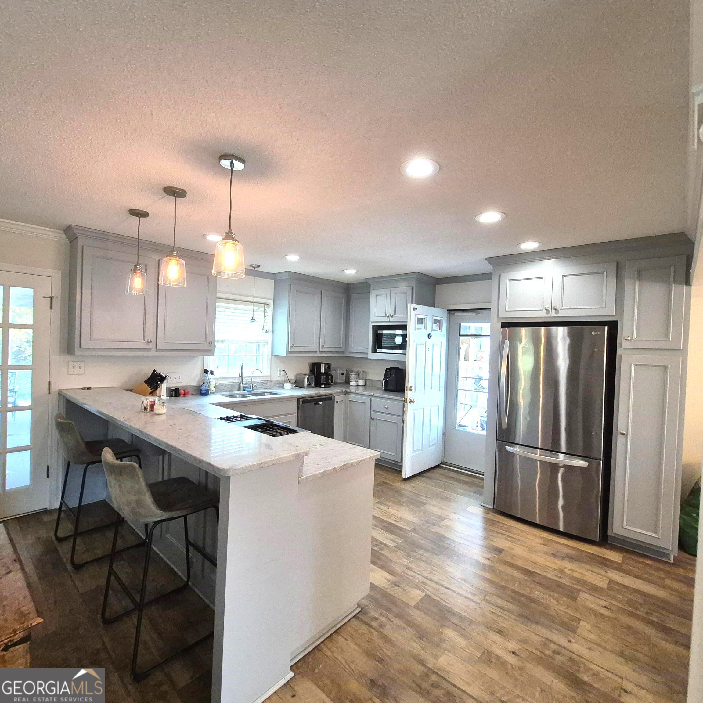 930 Hill Place Macon, GA 31210 - Photo 8 of 34 a kitchen with stainless steel appliances kitchen island granite countertop a refrigerator and a stove top oven