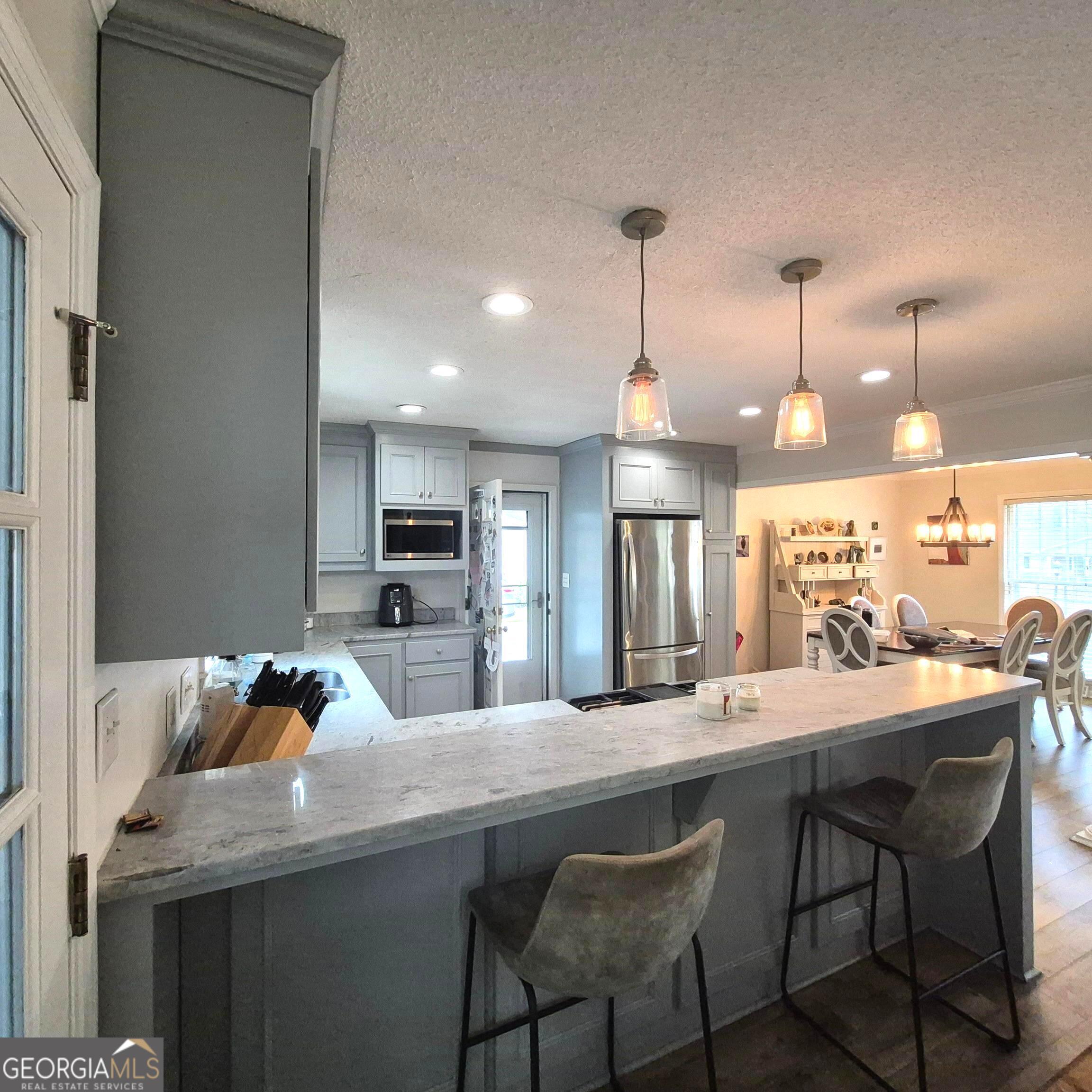 930 Hill Place Macon, GA 31210 - Photo 9 of 34 a kitchen with a dining table chairs and wooden floor