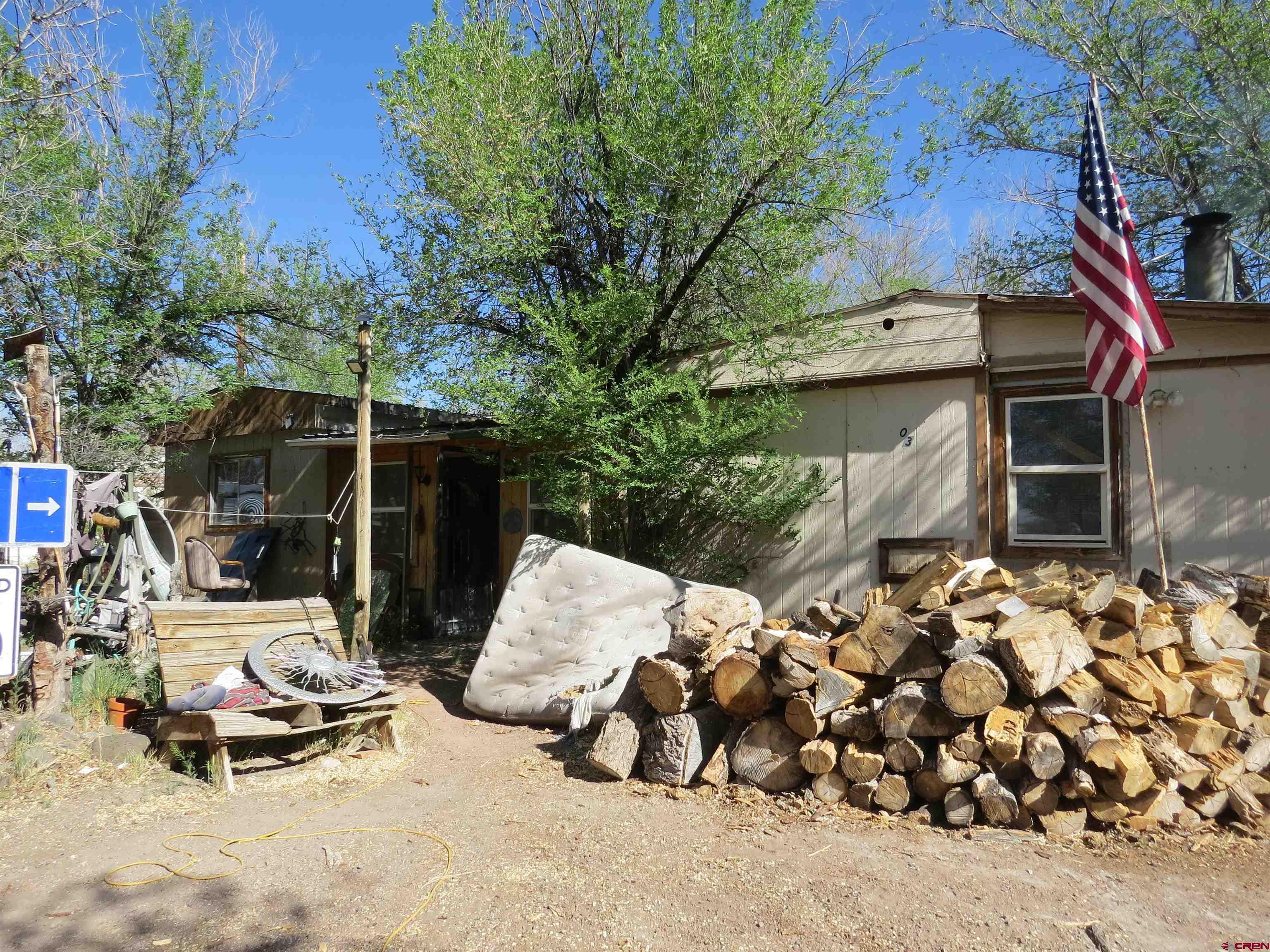 a view of backyard with outdoor seating and trees