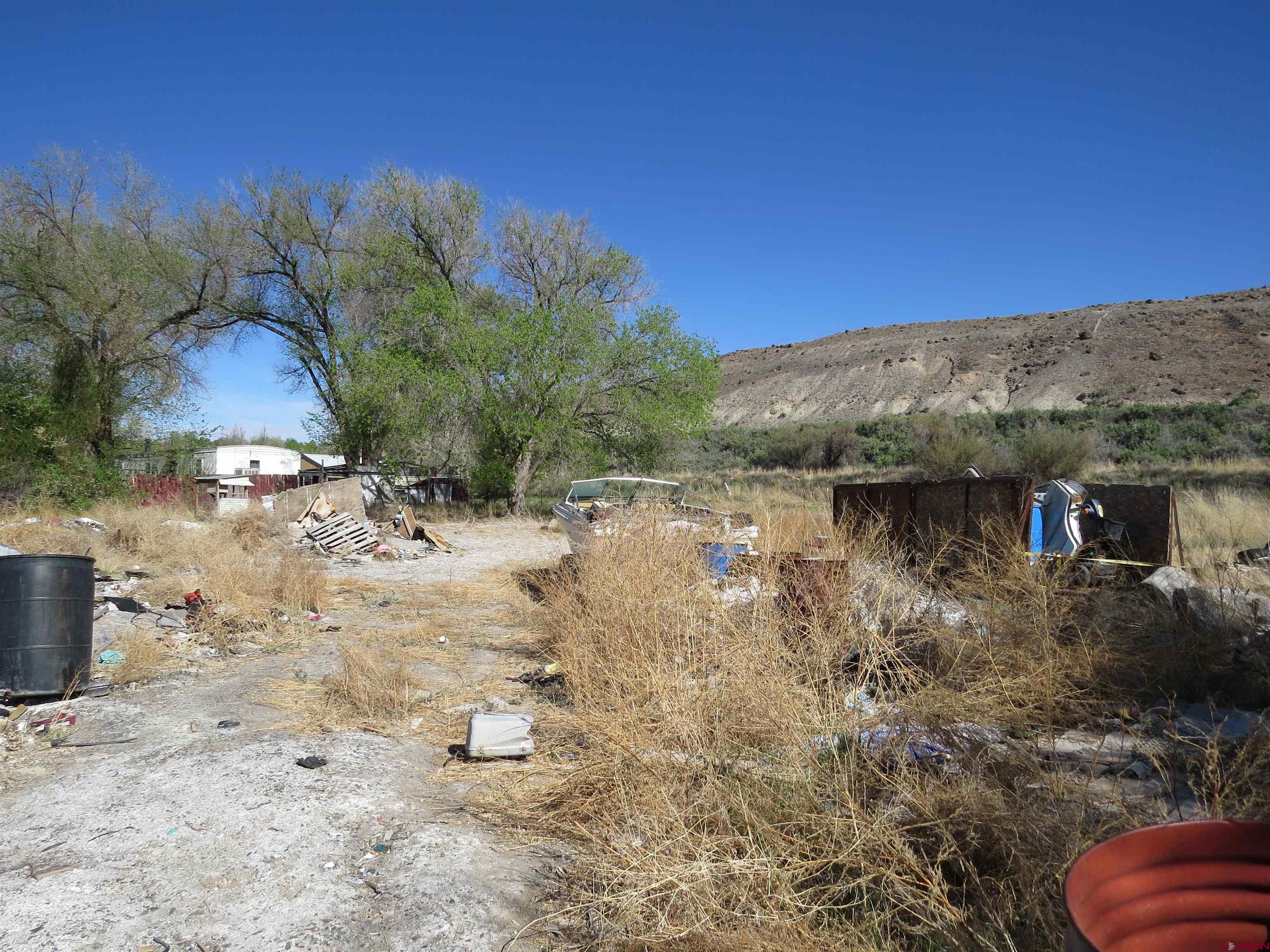 22203 Canal Street Austin, CO 81410 - Photo 18 of 20 a view of a dry yard with wooden fence