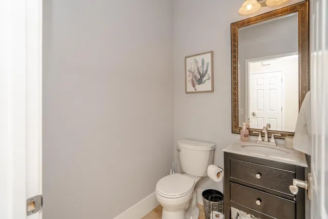 a bathroom with a toilet a sink and mirror