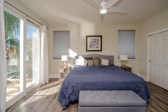 a spacious bedroom with a large bed and a chandelier