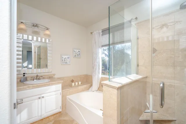 a bathroom with a tub sink and mirror