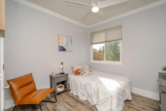 a bedroom with a bed and wooden floor