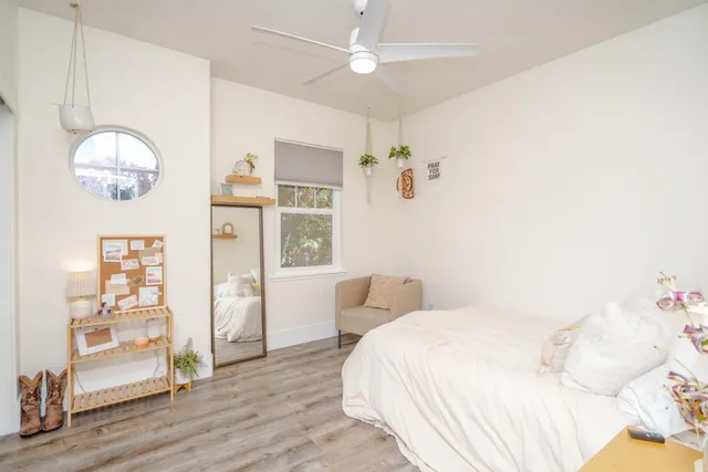 a bedroom with a large bed and a chandelier