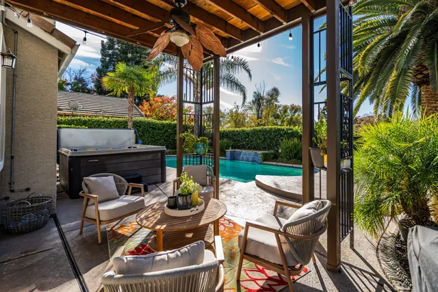a patio with water fountain and a fireplace