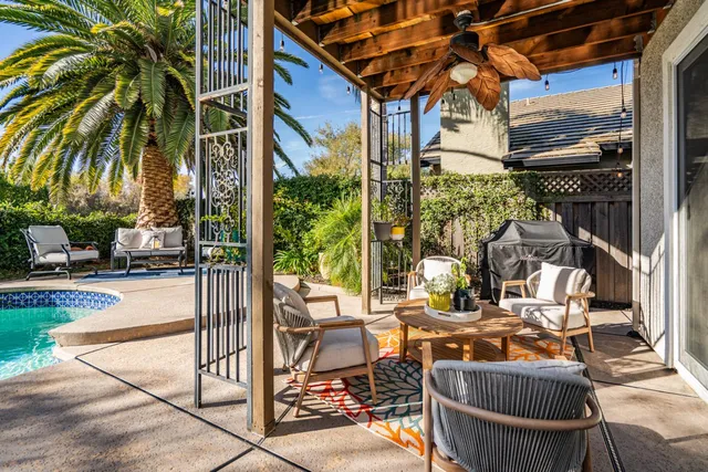 a view of a patio with table and chairs and potted plants