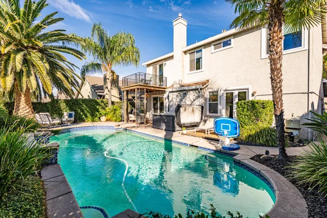 a swimming pool with outdoor seating and yard