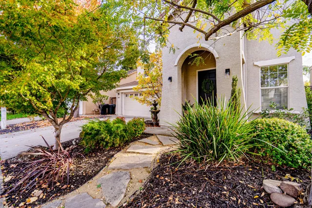 a front view of a house with garden