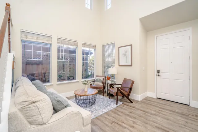 a living room with furniture and a floor to ceiling window