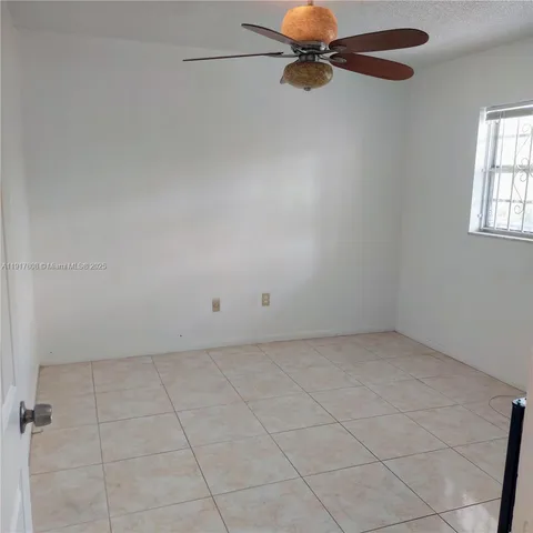 a view of an empty room with windows