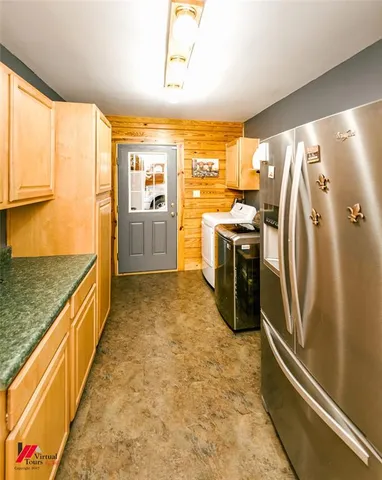 a spacious bedroom with a large bed a flat tv screen and a dresser