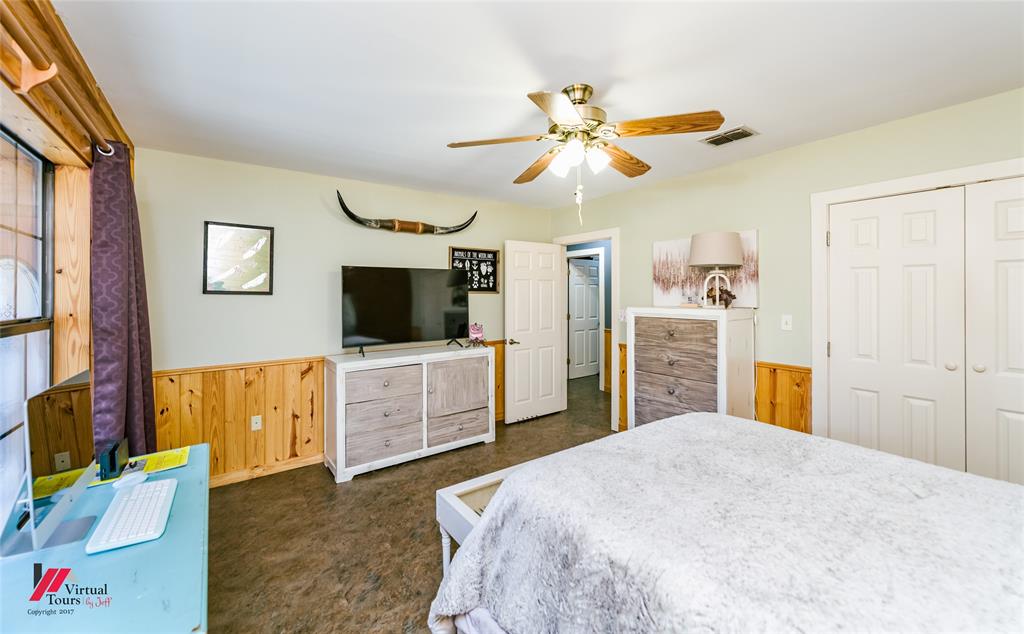 550 Middleton Road Stonewall, LA 71078 - Photo 26 of 40 a bedroom with a bed and a flat screen tv
