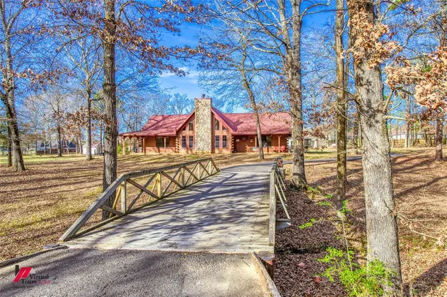 a living room with fireplace furniture and a large window