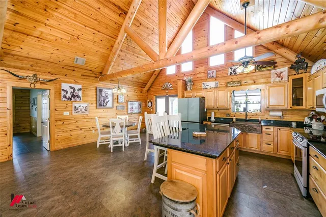 a kitchen with stainless steel appliances granite countertop a stove a sink and a counter space