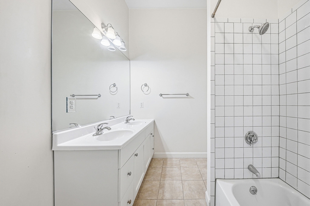 156 Chelsea Street, Unit 103 Boston, MA 02128 - Photo 17 of 27 a bathroom with a sink a shower and a mirror