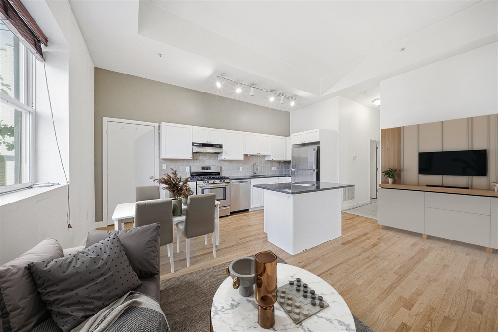 156 Chelsea Street, Unit 103 Boston, MA 02128 - Photo 2 of 27 a living room with furniture and a wooden floor