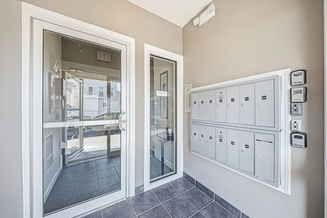 a view of a hallway with wooden floor and cabinet