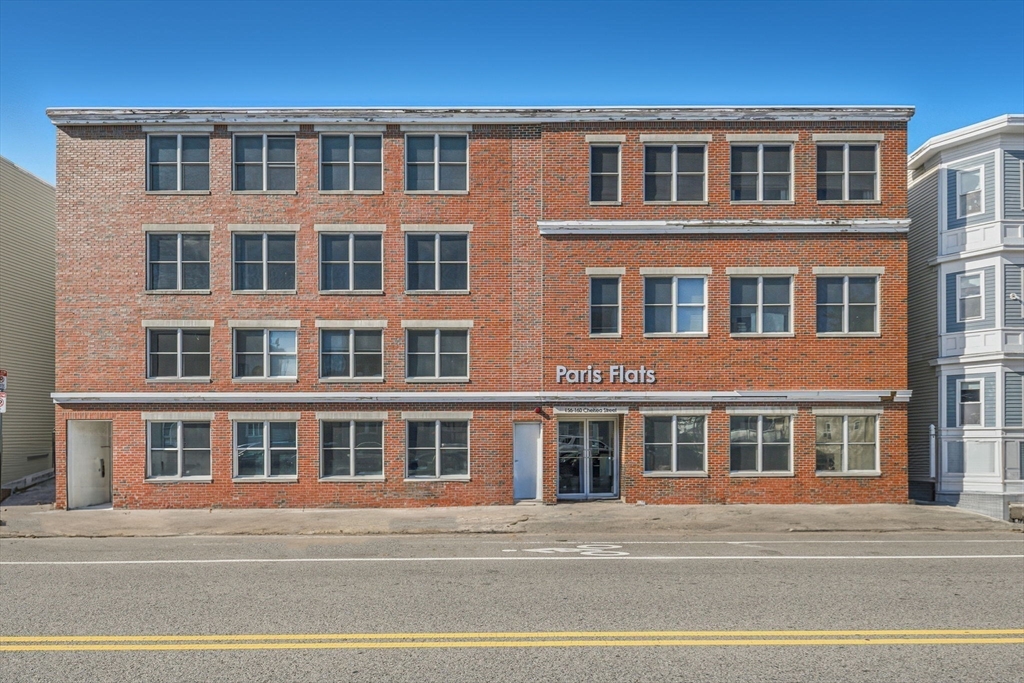 156 Chelsea Street, Unit 103 Boston, MA 02128 - Photo 25 of 27 a front view of a building with a street