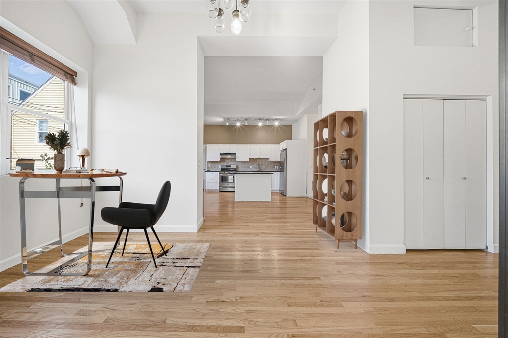 156 Chelsea Street, Unit 103 Boston, MA 02128 - Photo 5 of 27 a living room with furniture and a wooden floor