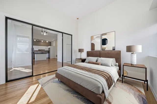 a spacious bedroom with a bed and a walk in closet