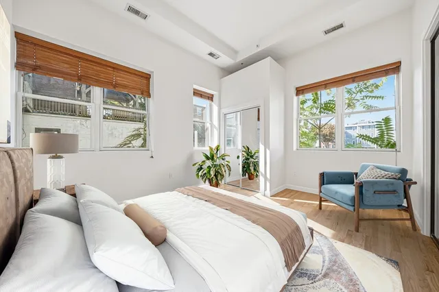 a bedroom with a bed and a large window