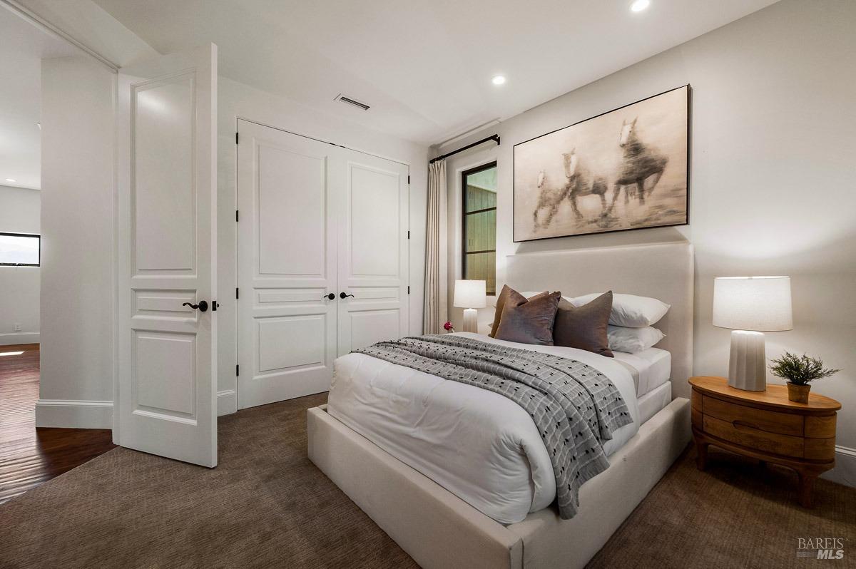 608 Seminary Drive Mill Valley, CA 94941 - Photo 47 of 67 a spacious bedroom with a bed and painting on the wall