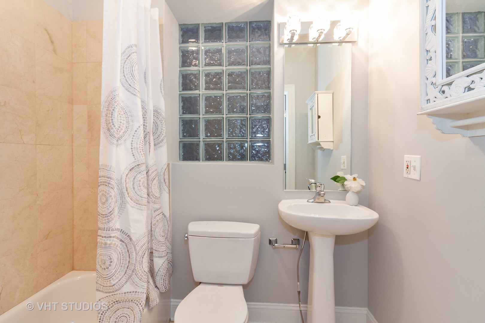 1345 West Fillmore Street, Unit 1 Chicago, IL 60607 - Photo 17 of 26 a bathroom with a sink toilet and shower