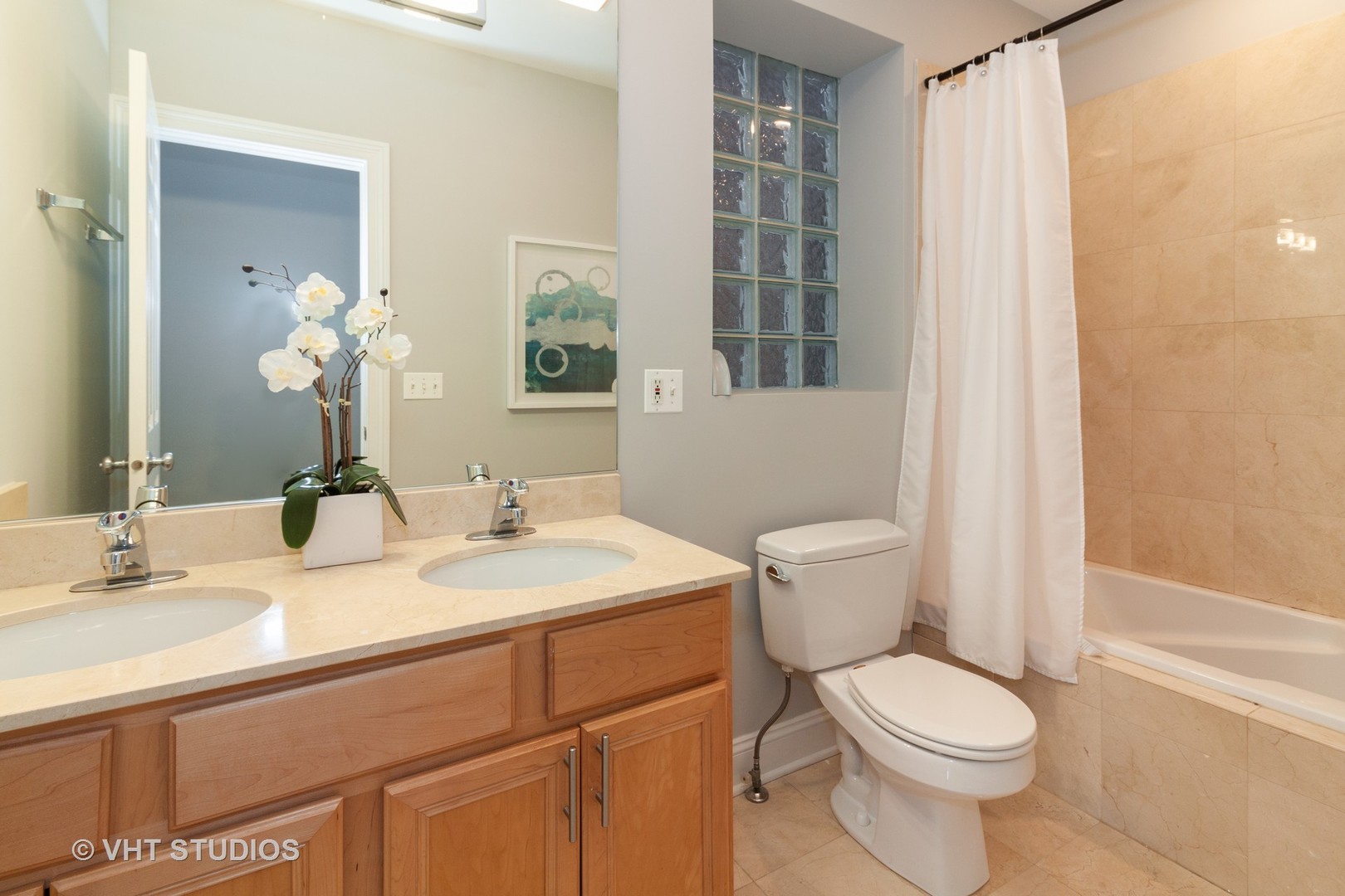 1345 West Fillmore Street, Unit 1 Chicago, IL 60607 - Photo 18 of 26 a bathroom with a sink a toilet and a mirror