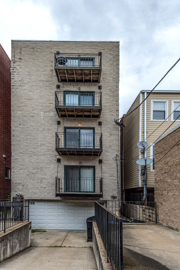 1345 West Fillmore Street, Unit 1 Chicago, IL 60607 - Photo 23 of 26 a front view of a house with a garage