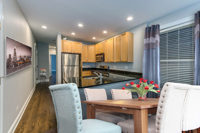 1345 West Fillmore Street, Unit 1 Chicago, IL 60607 - Photo 26 of 26 a kitchen with stainless steel appliances granite countertop sink refrigerator dining table and chairs