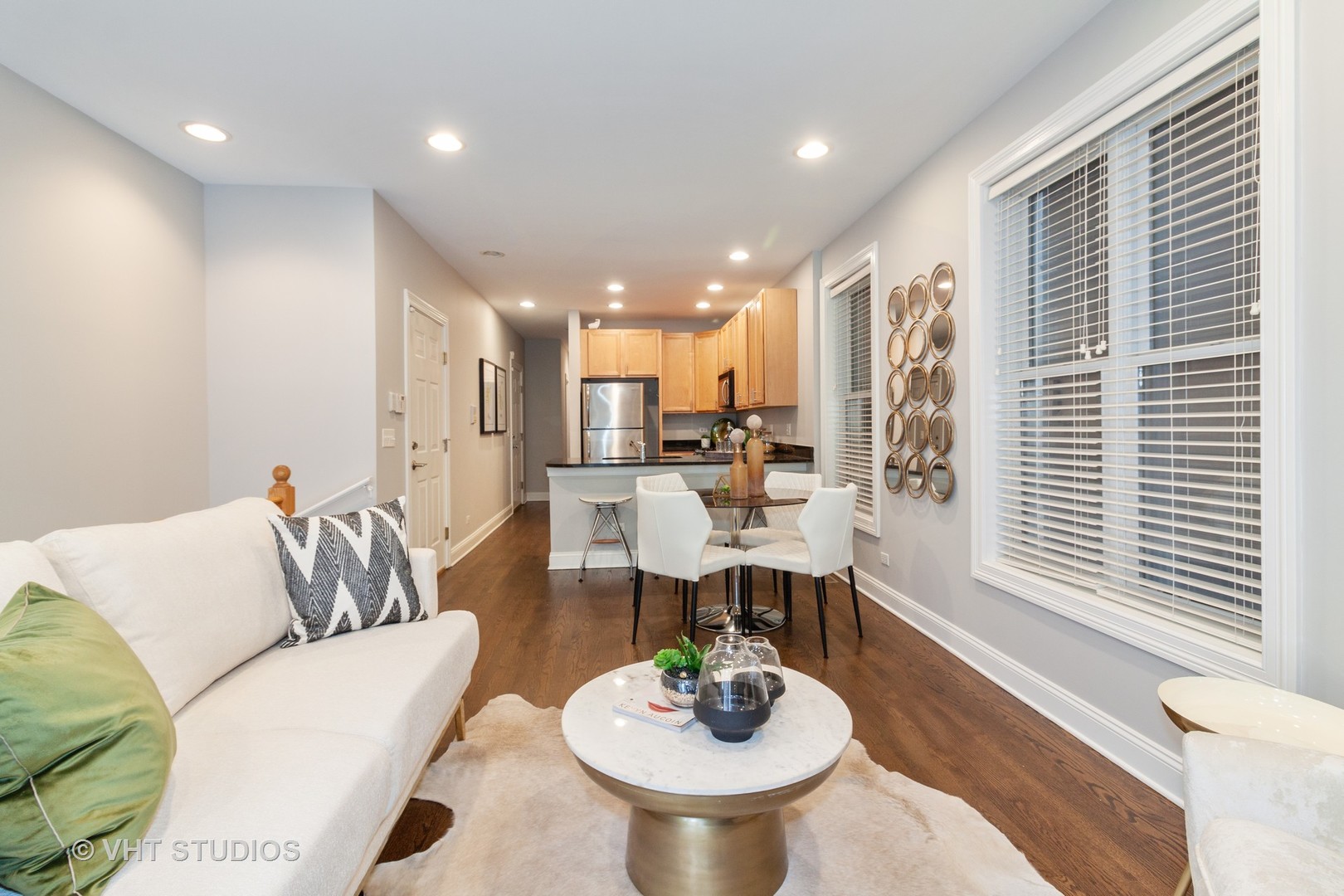 1345 West Fillmore Street, Unit 1 Chicago, IL 60607 - Photo 7 of 26 a living room with furniture and a dining table with kitchen view