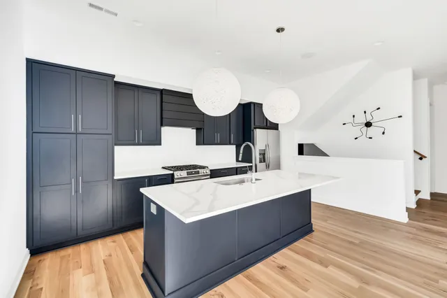 a kitchen with a sink cabinets and a wooden floor