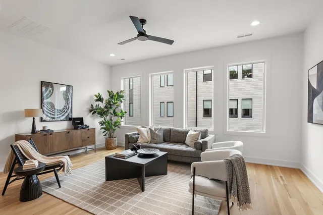 a living room with furniture and wooden floor
