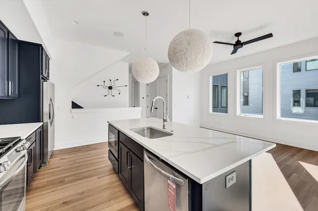 a bathroom with a granite countertop sink a toilet and bathtub