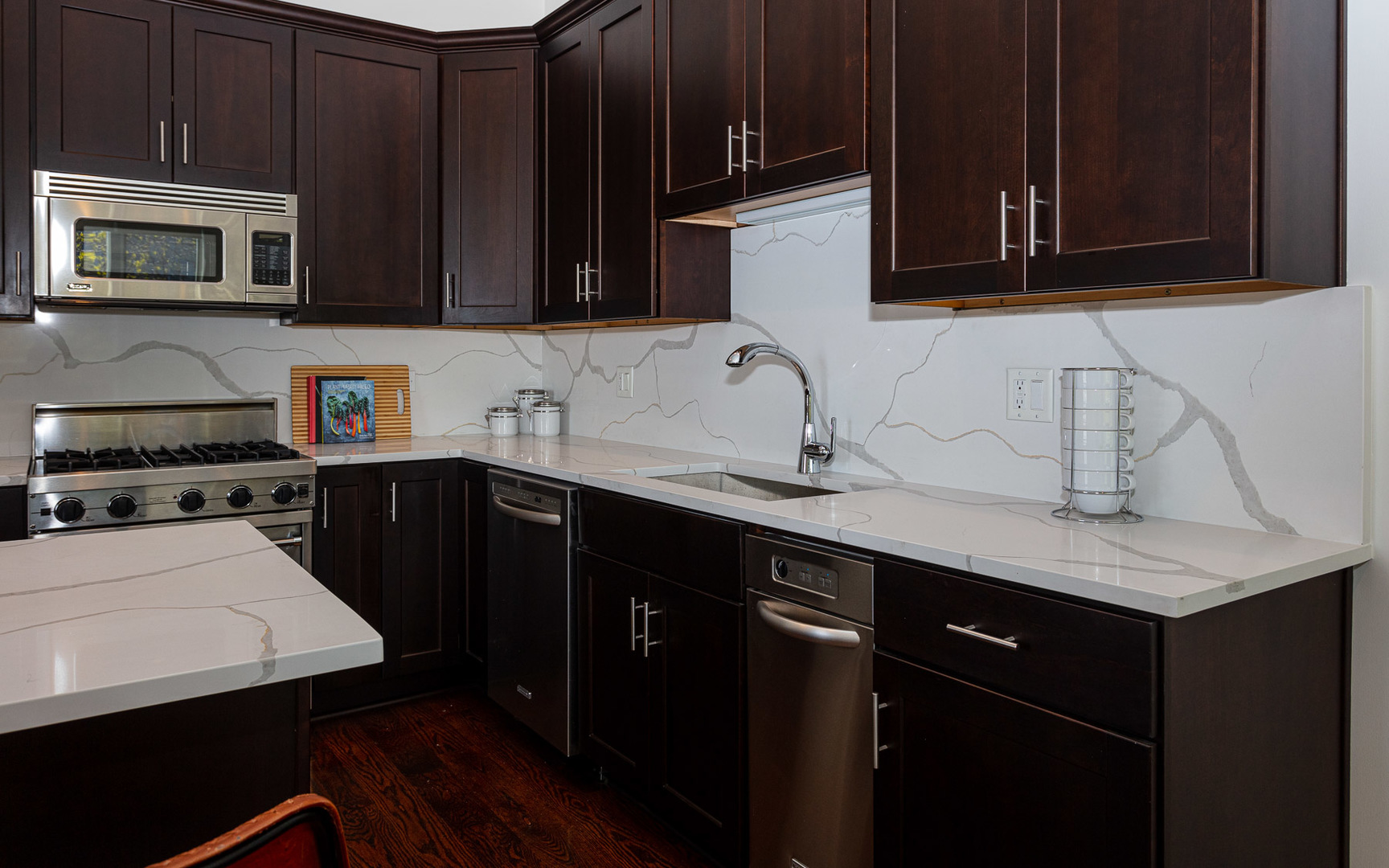 1838 West Rice Street, Unit 3 Chicago, IL 60622 - Photo 13 of 29 a kitchen with stainless steel appliances a sink dishwasher a stove microwave and cabinets