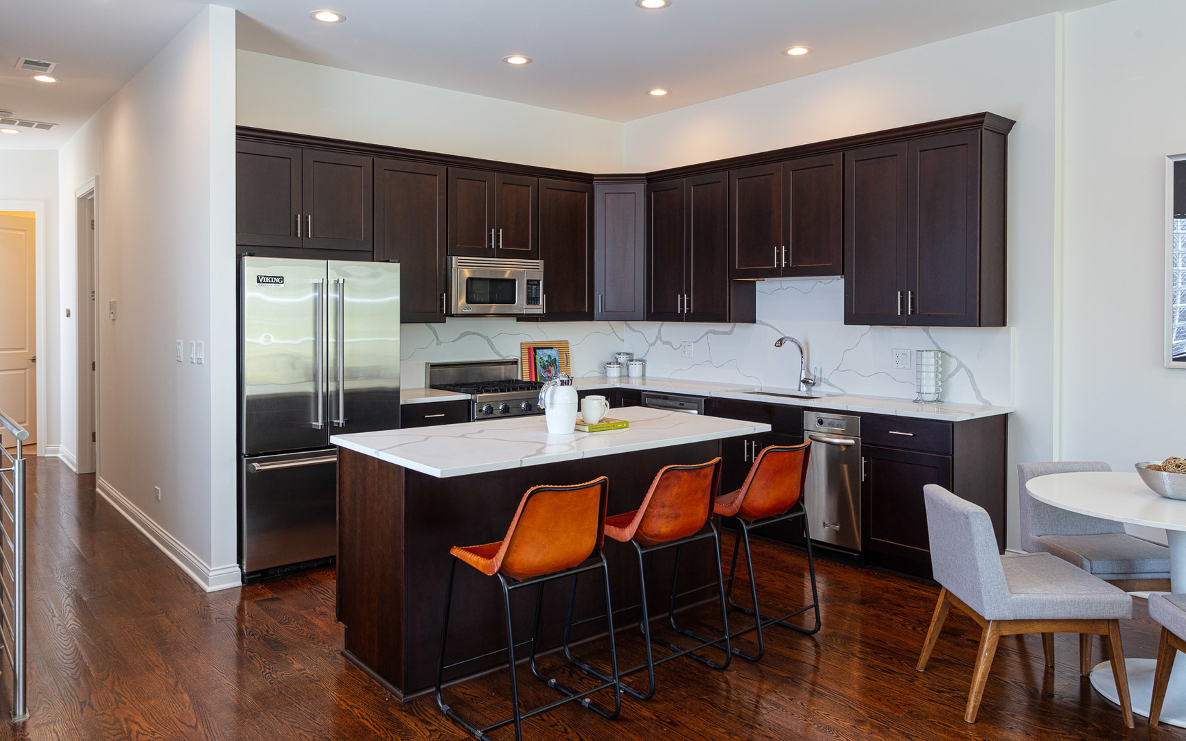 1838 West Rice Street, Unit 3 Chicago, IL 60622 - Photo 10 of 29 a kitchen with stainless steel appliances wooden cabinets granite counter tops a stove a sink and a refrigerator