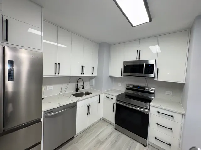 a kitchen with a stove and a refrigerator
