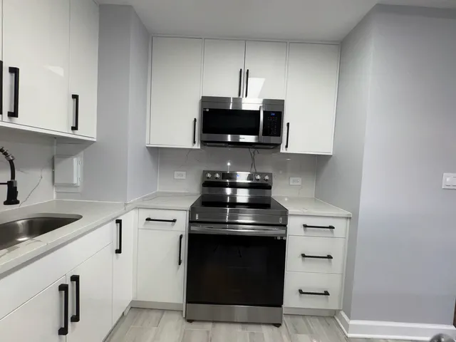 a kitchen with stainless steel appliances a refrigerator stove and sink
