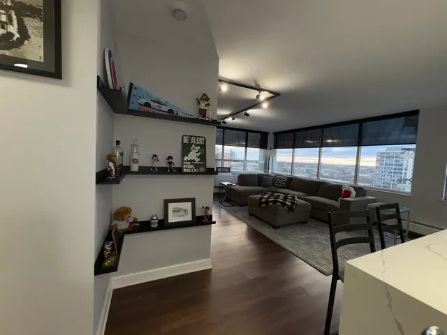 a kitchen with a table chairs refrigerator and cabinets