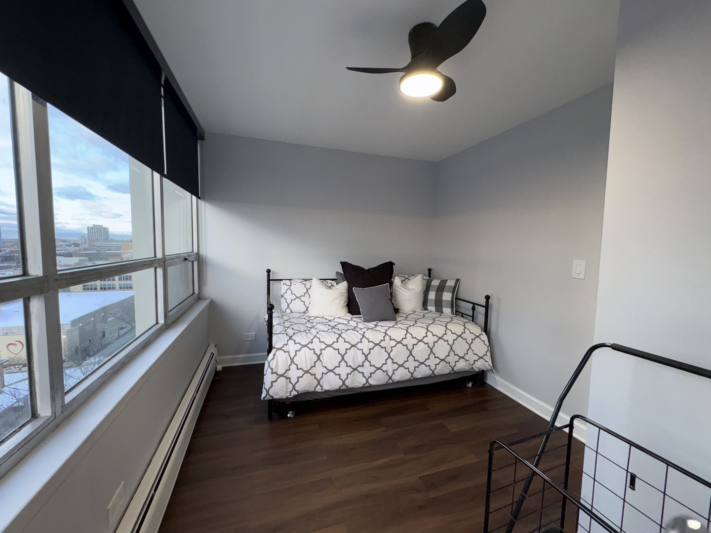 6171 North Sheridan Road, Unit 1102 Chicago, IL 60660 - Photo 25 of 39 a bedroom with a bed lamp and a large window with wooden floor