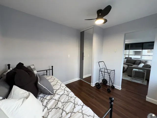 a large bed sitting in a bedroom next to a window