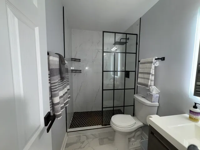 a bathroom with a sink toilet and shower