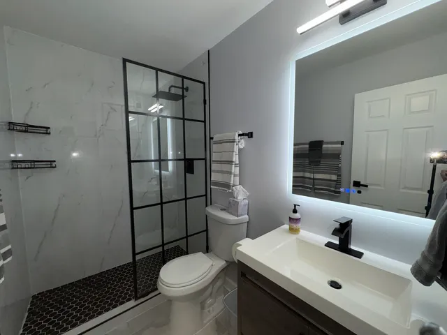 a bathroom with a sink toilet and shower