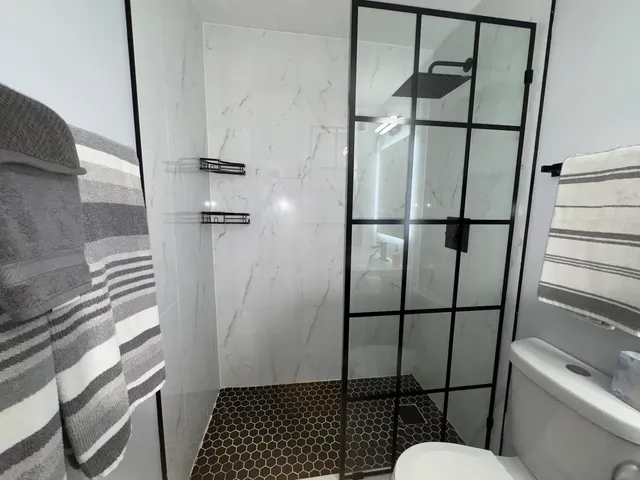 a bathroom with a sink toilet and shower