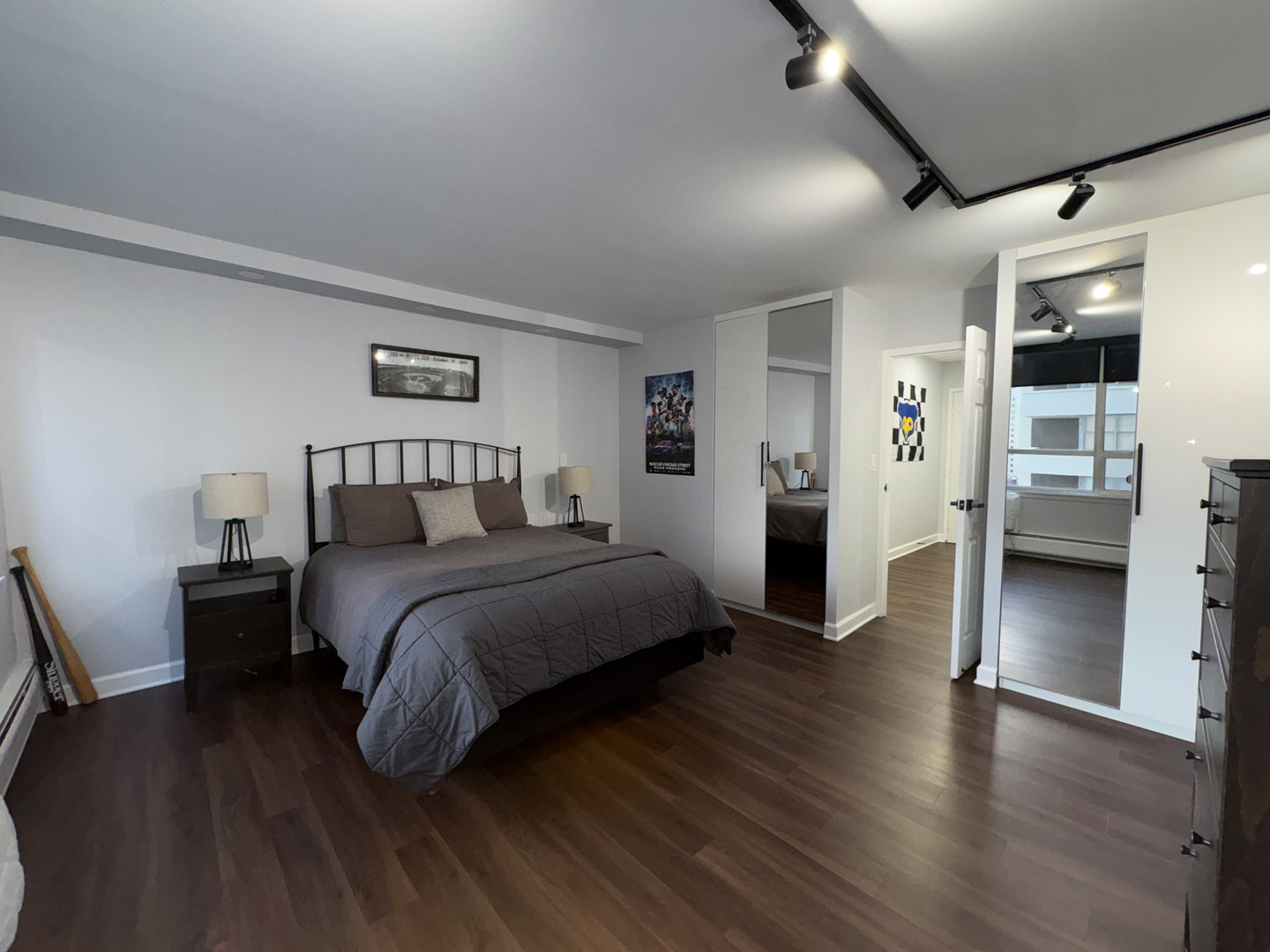 6171 North Sheridan Road, Unit 1102 Chicago, IL 60660 - Photo 35 of 39 a bedroom with a large bed and a wooden floor