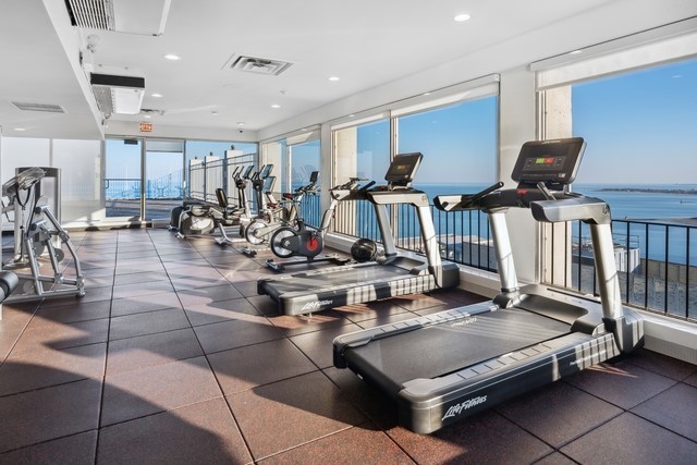 6171 North Sheridan Road, Unit 1102 Chicago, IL 60660 - Photo 8 of 39 a living room with gym equipment